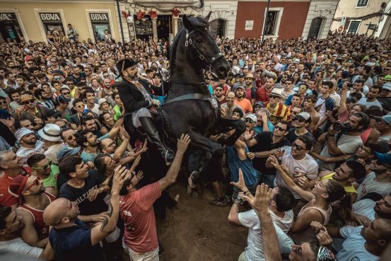 A 'caixer' (horse rider) rears up on his horse during the Gracia Festival in Mahon, Spain, Sept. 8, 2018