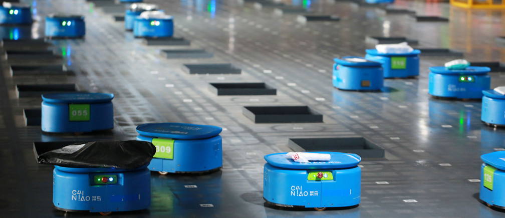 Robots operated by Alibaba's logistics unit Cainiao, move parcels at a new automated guided vehicles (AGV) warehouse inside the hub of delivery company YTO Express, in Hangzhou, Zhejiang province, China September 14, 2018. Picture taken September 14, 2018. REUTERS/Stringer